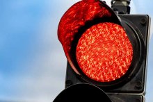 How Must You React To A Flashing Red Traffic Light?