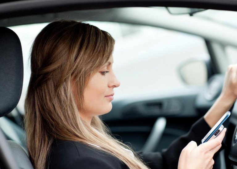 Distracted driver on her phone.