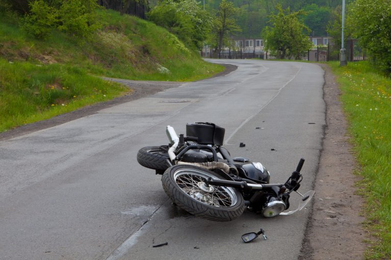 Motorcycle crashed on country road.