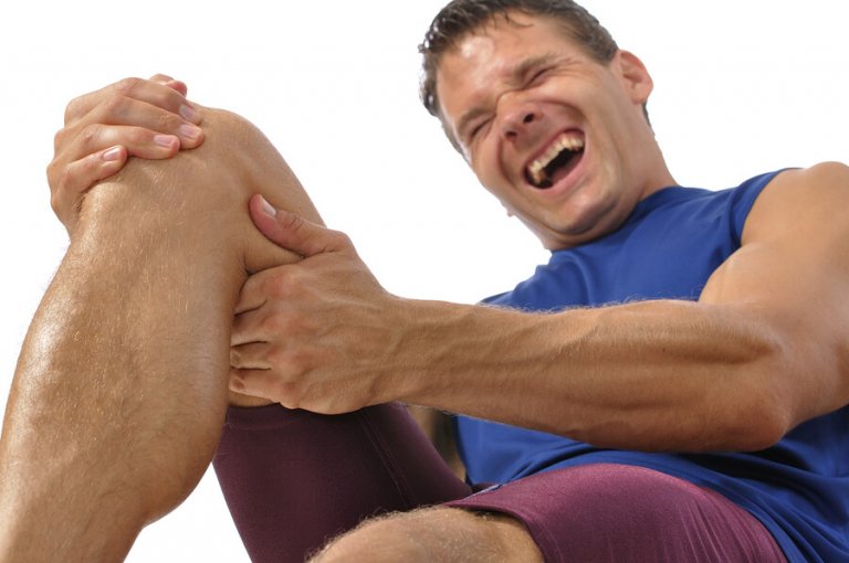 A man stretching out his left leg.