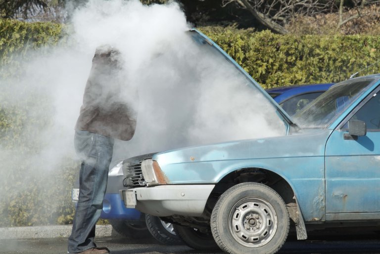 Car overheating on side of road.